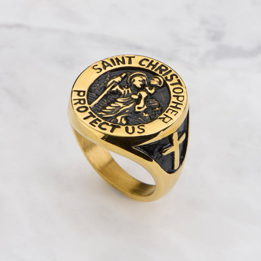 Gold ring with Saint Christopher design on a light gray background