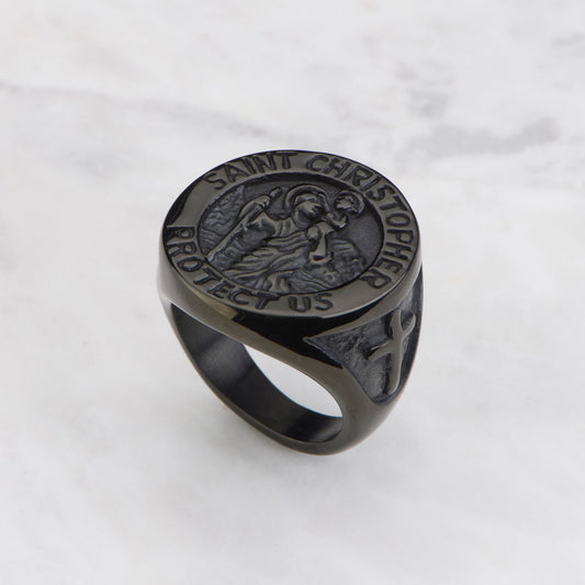 Black ring with engraved design on a white background