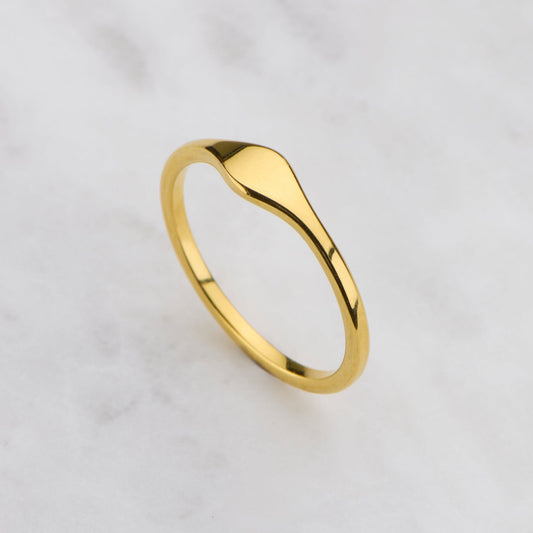 Gold ring on a light gray background