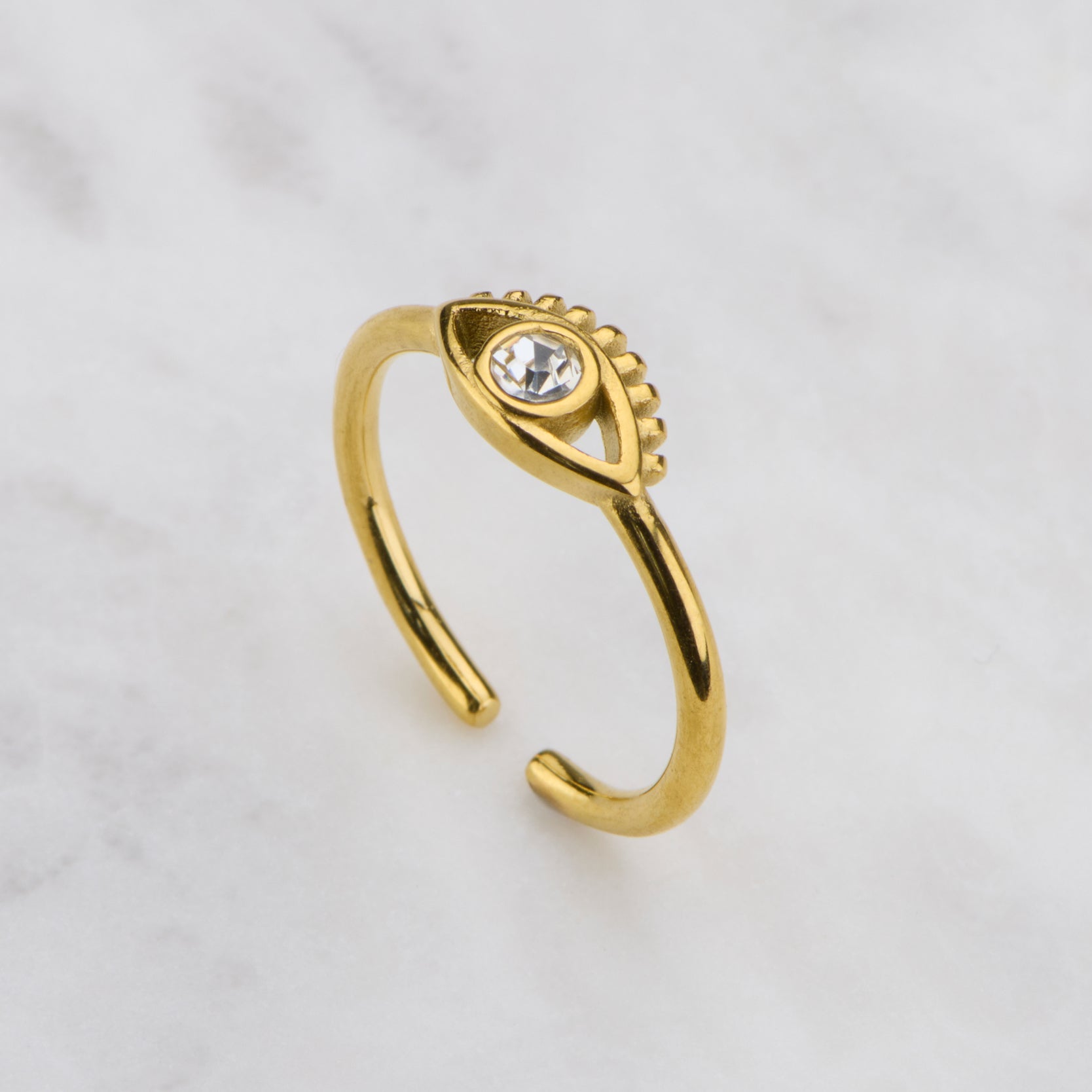 Gold ring with a gemstone on a light gray background