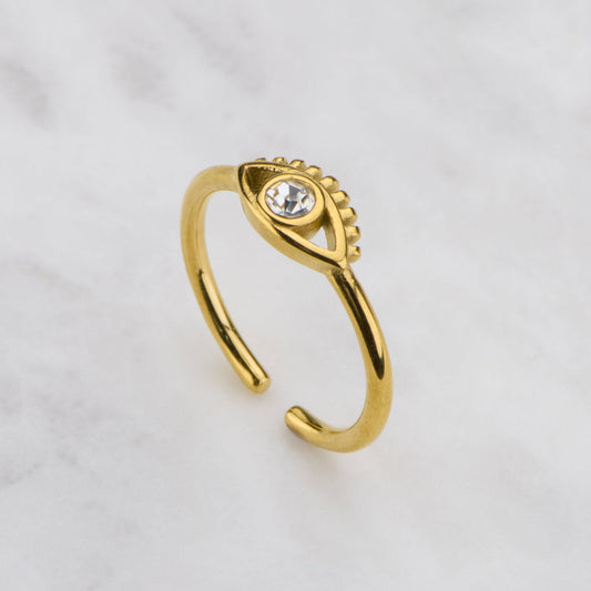 Gold ring with a gemstone on a light gray background