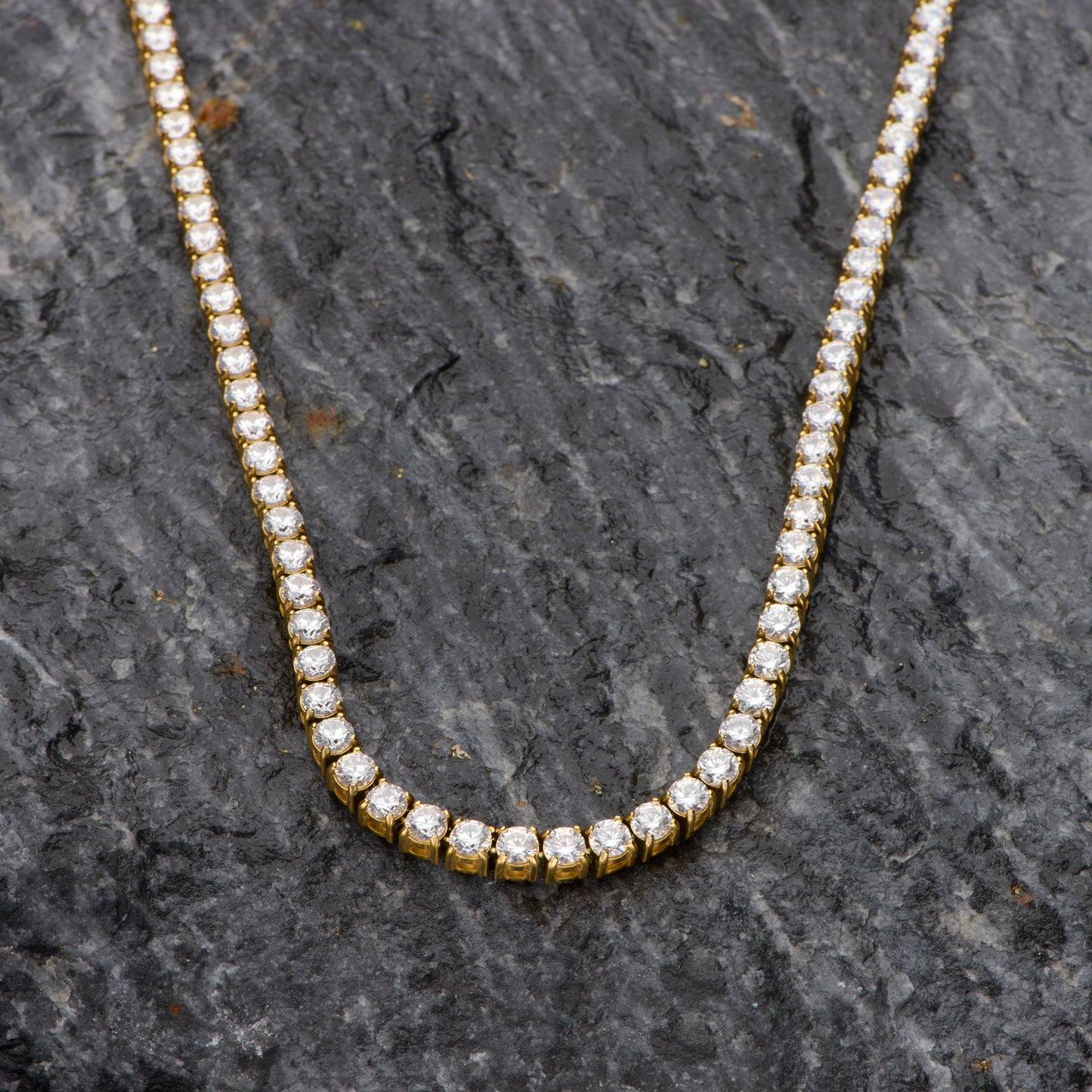 Diamond necklace on a dark stone surface