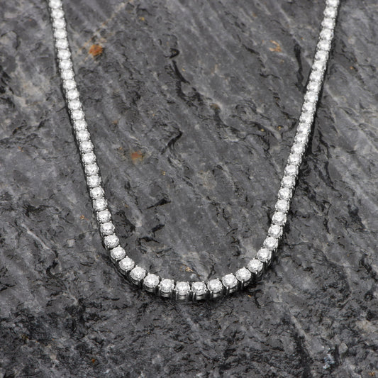 Diamond necklace on a dark stone surface
