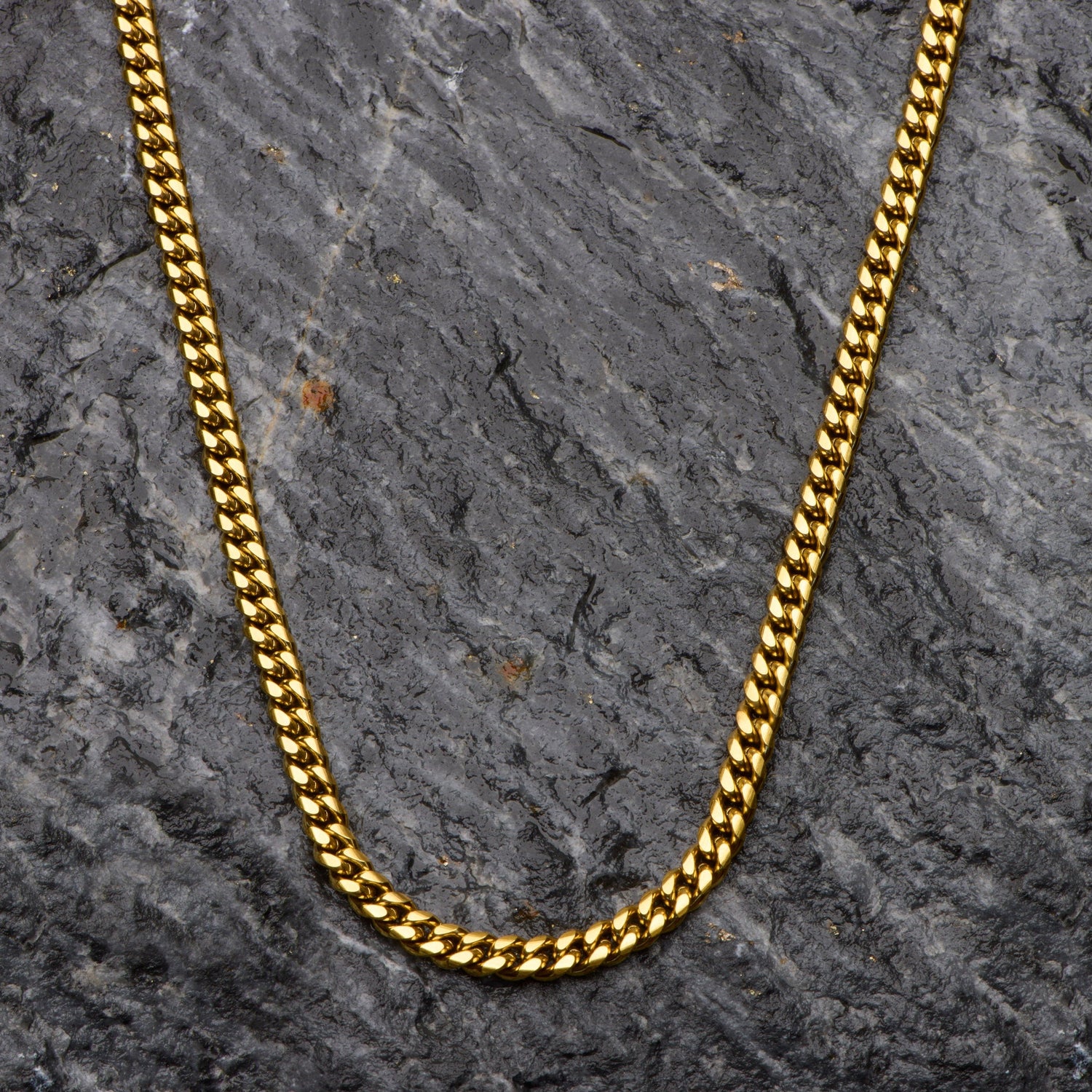 Gold chain on a textured dark gray surface