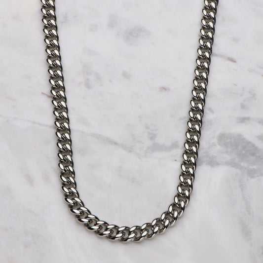 Silver chain necklace on a marble surface