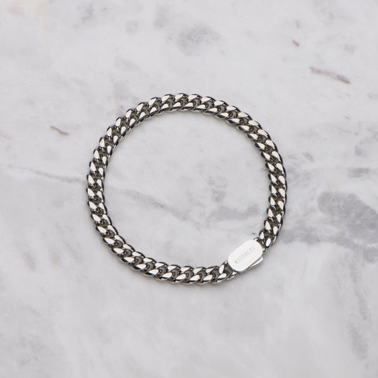 Silver chain bracelet on a marble surface