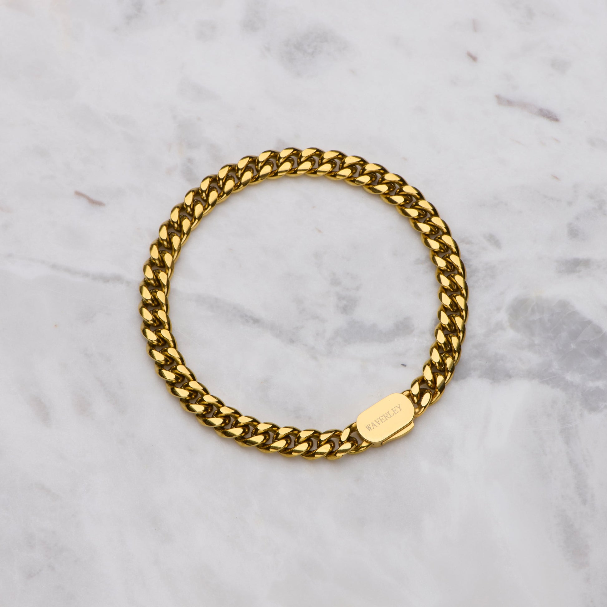 Gold chain bracelet on a marble surface