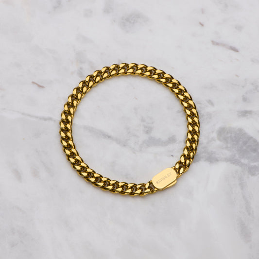 Gold chain bracelet on a marble surface