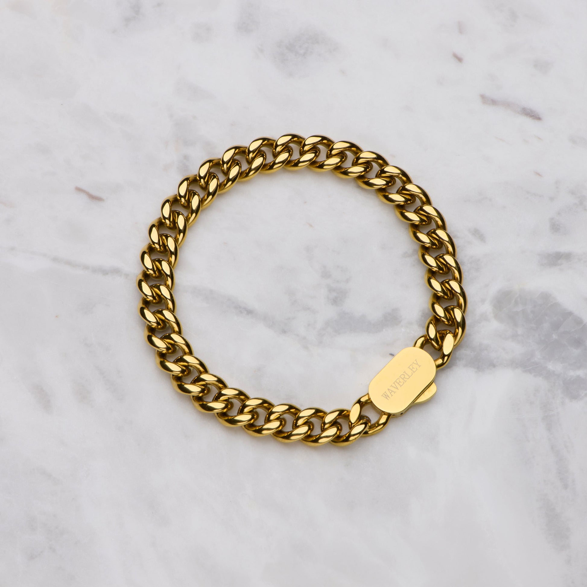 Gold chain bracelet on a marble surface