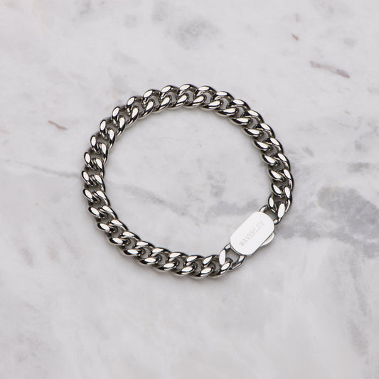 Silver chain bracelet on a marble surface