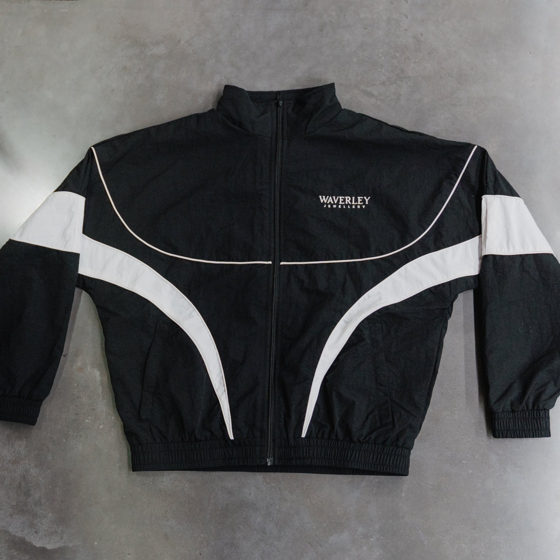 Black jacket with white accents on a gray background