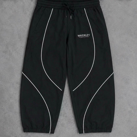 Black pants with white piping on a grey background