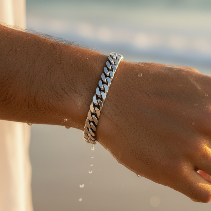 Close-up of silver Miami Cuban bracelet with tight rounded links at beach