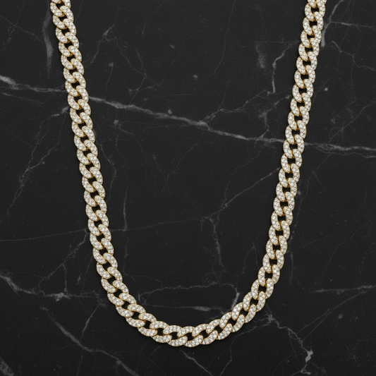 Gold chain necklace on a black marble surface