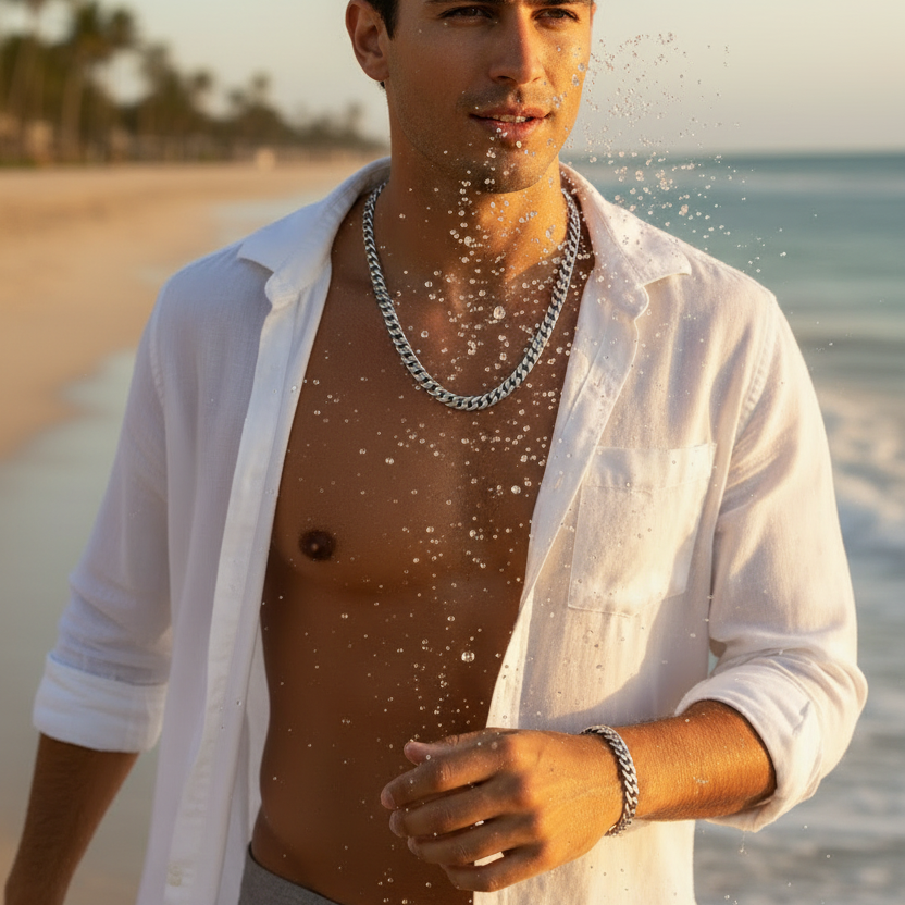 Male model wearing matching silver Miami Cuban chain and bracelet at beach in motion