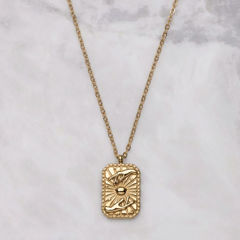 Tarot necklace in gold on marble